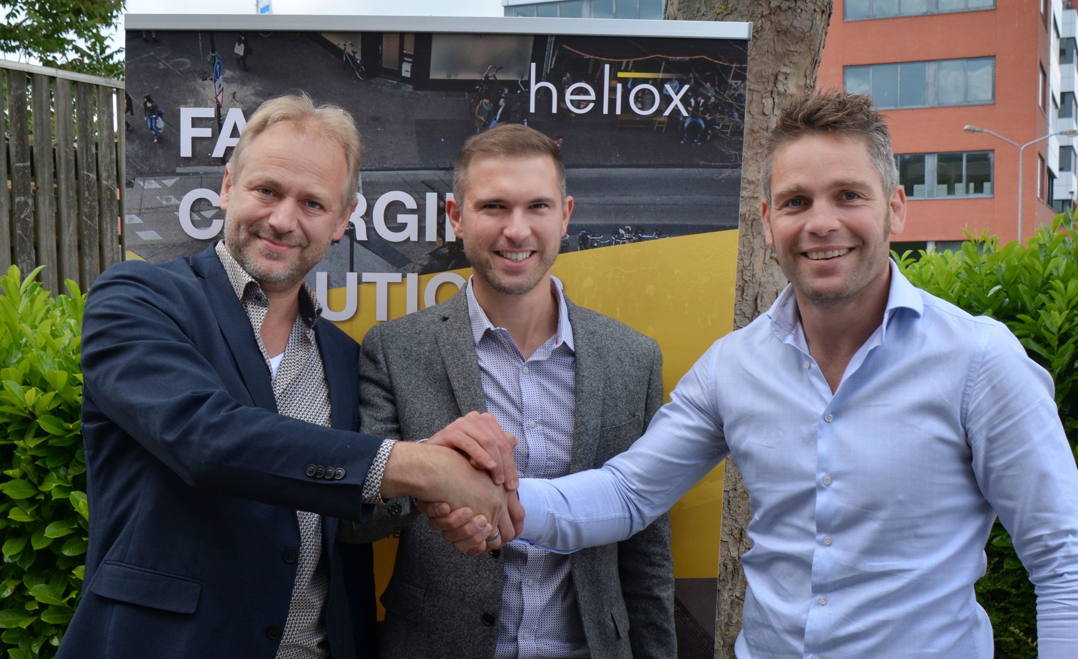 Mark Smidt (Managing Director Heliox) , Stefan Smolenaers (Managing Director Inverted Power) and Bob Bouhuijs (Director Automotive Heliox) shake hands to certify their co-operation.